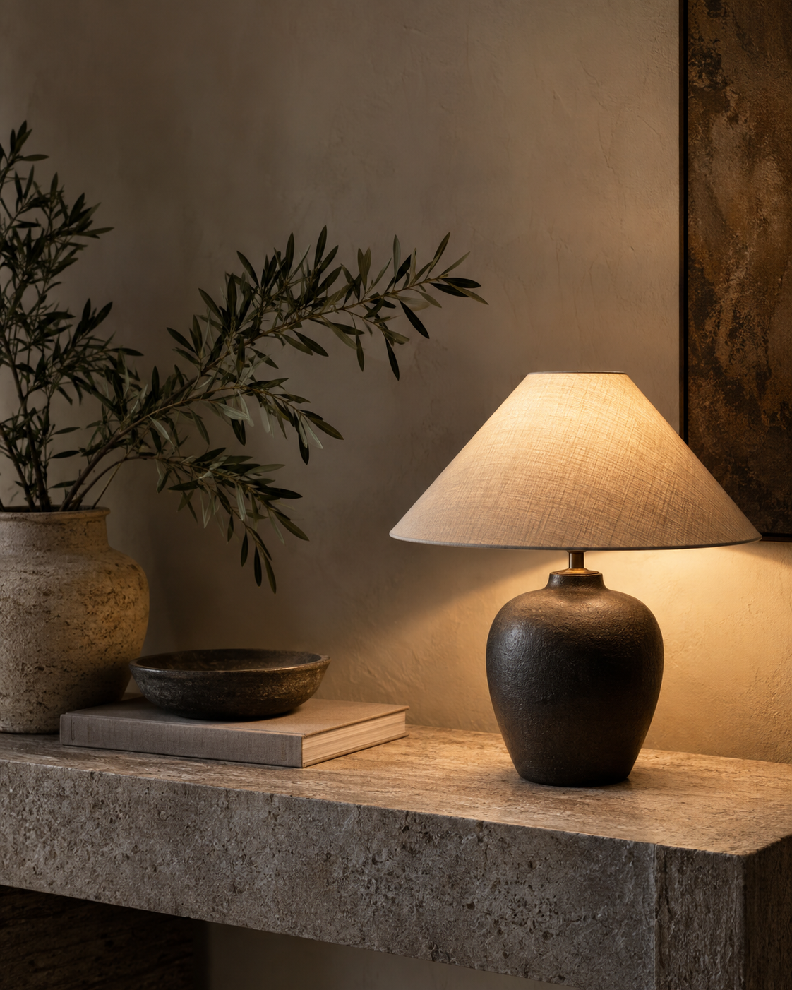 Warm table lamp creating an intimate atmosphere on a stone console